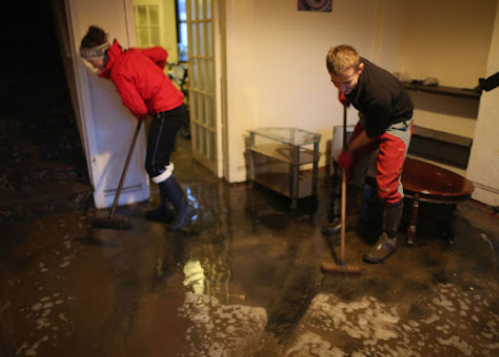 Flood cleanup crew removing standing water